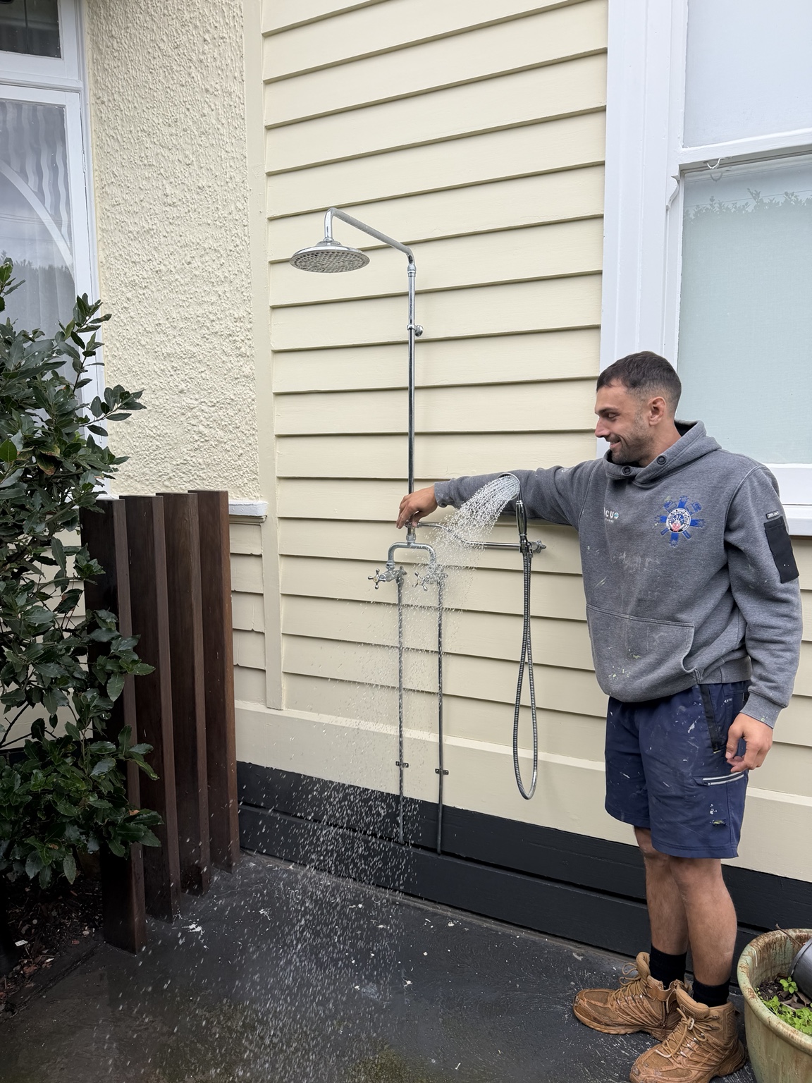 MonkFlo plumber testing a newly installed outdoor shower at a Melbourne home